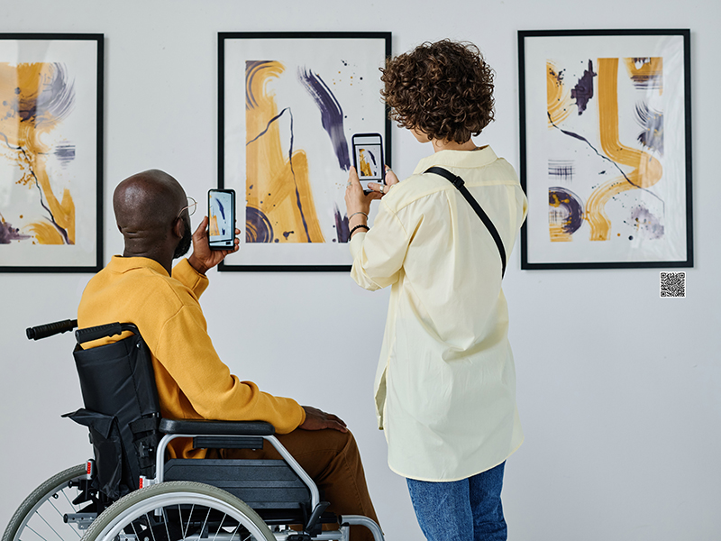 Couple making photo of modern art